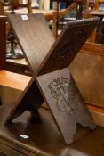 AN OAK CARVED 'X' FRAMED BIBLE/BOOK STAND