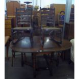 AN OAK OVAL GATE LEG DINING TABLE, ON BALUSTER LEGS AND A PAIR OF DARK ELM LADDER BACK SINGLE