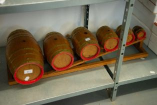 A SET OF SIX HANDMADE MINIATURE BREWERY BARRELS ON STAND