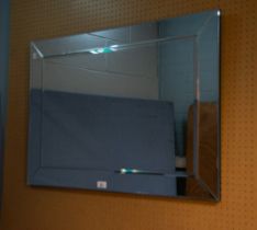 A MODERN FRAMELESS RECTANGULAR WALL MIRROR