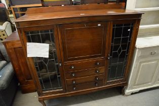 AN EARLY TWENTIETH CENTURY MAHOGANY SIDE BY SIDE BUREAU BOOKCASE, THE CENTRAL SECTION HAVING DROP-