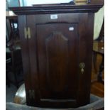 A SMALL OAK REPRODUCTION CORNER CUPBOARD