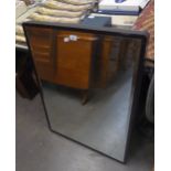 A LARGE RECTANGULAR BEVELLED EDGE WALL MIRROR IN BLACK FRAME