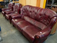 A THREE PIECE LOUNGE SUITE, WOODEN FRAMED AND OX-BLOOD LEATHER ON CABRIOLE FRONT FEET