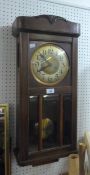 AN EARLY TWENTIETH CENTURY OAK CASED PENDULUM WALL CLOCK/REGULATOR