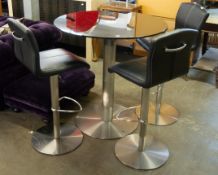 A BLACK GLASS TOPPED CIRCULAR TALL TABLE, WITH BRUSHED STEEL PEDESTAL BASE, TOGETHER WITH THREE TALL