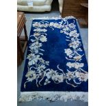 A BLUE GROUND CHINESE CARPET (175cm x 90cm)