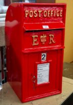 A REPRODUCTION BRITISH POST BOX, IN RED WITH GOLD COLOURED WRITING