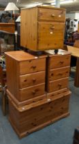 A MODERN PINE BEDDING BOX, A PAIR OF PINE THREE DRAWER BEDSIDE CHESTS AND A TWO DRAWER PINE FILING