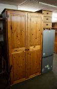 A PINE TWO DOOR WARDROBE, SHELF AND HANGING RAIL AND A SIMILAR PINE 3 DRAWER BEDSIDE CABINET (2)
