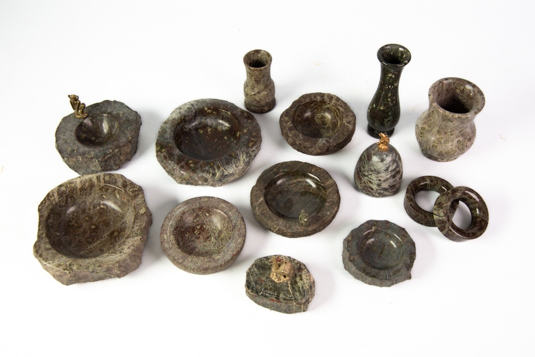 CORNISH SERPENTINE: Assorted serpentine items including napkin rings, ashtrays, paperweights, and