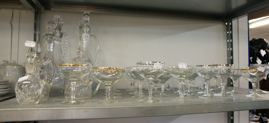 FOUR GLASS DECANTERS, CUT GLASS AND MOULDED GLASS, 3 OIL BOTTLES AND APPROX 26 CHAMPAGNE COUPES