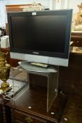 PANASONIC 26" TV WITH REMOTE CONTROL AND A SMALL CLEAR PERSPEX TABLE (2)