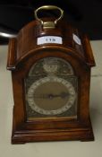 MODERN GEORGIAN STYLE FIGURED WALNUT CASED QUARTZ MANTLE CLOCK, with top handle