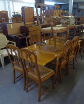 CONTINENTAL OAK DRAW LEAF DINING TABLE, WITH SERPENTINE EDGE AND SUPPORTED ON CABRIOLE LEGS TO