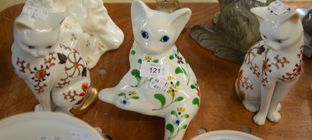 PAIR OF ORIENTAL WHITE PORCELAIN MODELS OF SEATED CATS, PAINTED WITH IMARI FLORAL DECORATION, 8 3/8"