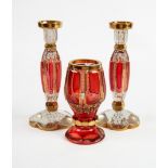 PAIR OF MURANO RUBY GLASS AND GILT CANDLESTICKS, 7” (17.8cm) high, together with a SIMILAR FIRING