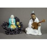 CHINESE 20th CENTURY SEATED FIGURE OF A MUSICIAN playing a lute and having glazed robe and brown
