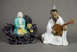 CHINESE 20th CENTURY SEATED FIGURE OF A MUSICIAN playing a lute and having glazed robe and brown