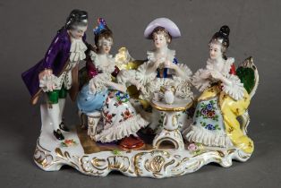 20th CENTURY CONTINENTAL CHINA LACE GROUP OF A COURTIER STANDING BY THREE LADIES, seated round a