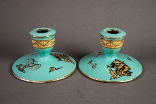 PAIR OF CARLTON WARE SQUAT CANDLE HOLDERS, with turquoise ground, the campana shaped sconce with