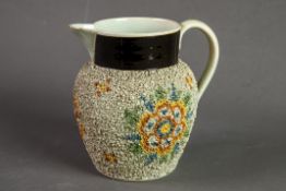 VICTORIAN GRAVELWARE PEARLWARE POTTERY JUG, decorated in colours with stylised flowerheads beneath a