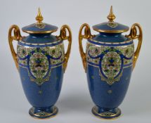 PAIR OF EARLY TWENTIETH CENTURY ROYAL WORCESTER POWDER BLUE PORCELAIN TWO HANDLED VASES AND