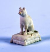 NINETEENTH CENTURY ROCKINGHAM BISCUIT PORCELIAN MODEL OF A SEATED CAT, on an oblong tassled