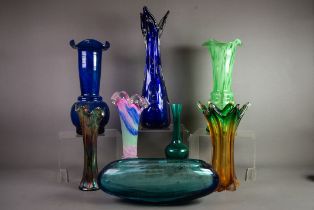 SEVEN COLOURED STUDIO GLASS VASES, various shapes and designs, together with a GREEN CARNIVAL