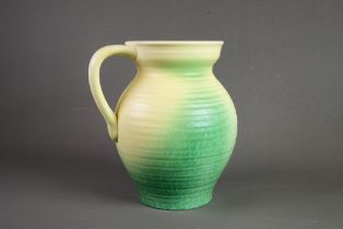 ROYAL CAULDON POTTERY LARGE JUG, of ribbed form with loop handle, glazed in fading tones of yellow