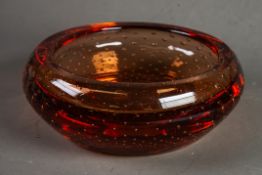 CIRCA 1960's MURANO APRICOT TINTED GLASS SHALLOW BOWL with turned-over rim, enclosing multiple AIR