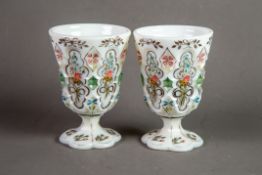 PAIR OF NINETEENTH CENTURY HAND PAINTED AND MOULDED MILK GLASS GOBLETS, each of typical form with