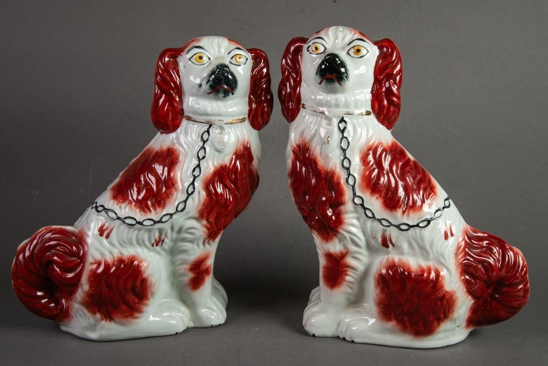 PAIR OF 19th CENTURY STAFFORDSHIRE POTTERY SEATED MANTEL DOGS, red/brown and white with collar and