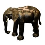 LIBERTY’S STYLE MODERN BLACK LEATHER COVERED MODEL OF AN ELEPHANT, with trunk down, flapping ears