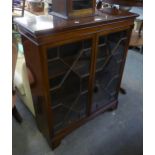 A MAHOGANY TWENTIETH CENTURY GLAZED BOOKCASE ON BRACKET FEET