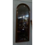 A WALL MIRROR MILESTONE SHAPED IN MAHOGANY FRAME