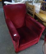 A VICTORIAN UPHOLSTERED LOW SEATED ARMCHAIR, COVERED IN RED VELVET (A.F.)