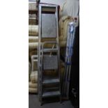 A LARGE SET OF ALUMINIUM STEP LADDER, A SMALLER PAIR AND A ROTARY CLOTHES AIRER (AS NEW) (3)