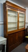 AN OAK TWO SECTION GLASS DOOR BOOKCASE, TWO GLASS DOORS, 'ONE SLIDING', LOWER SECTION ALSO HAS ONE
