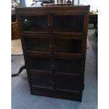 AN OAK FOUR TIER BOOKCASE, EACH TIER WITH TWO GLAZED DOORS