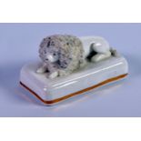 NINETEENTH CENTURY STAFFORDSHIRE MODEL OF A RECUMBENT CLIPPED POODLE, on an oblong, gilt lined base,