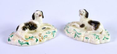 PAIR OF NINETEENTH CENTURY STAFFORDSHIRE PORCELAIN MODELS OF RECUMBENT KING CHARLES SPANIELS, each