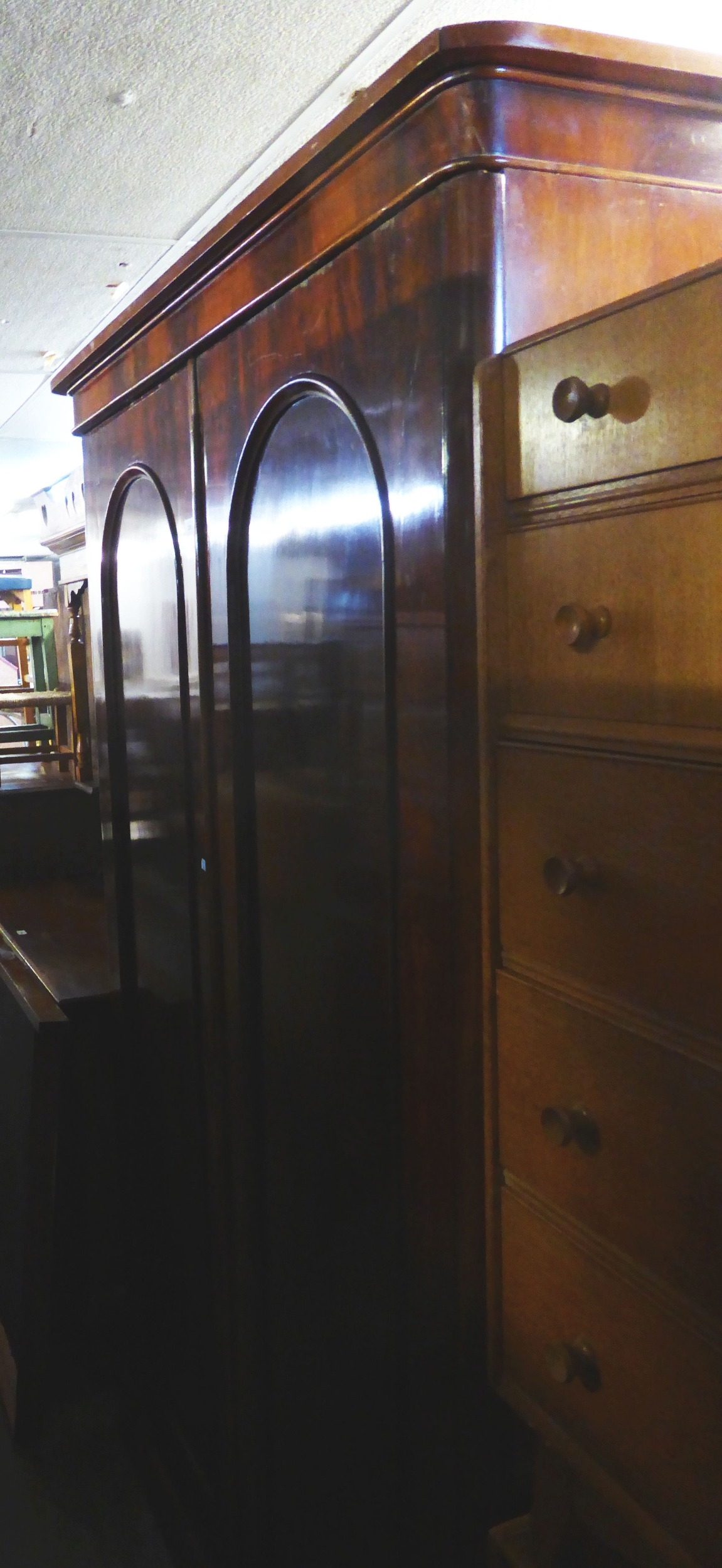 A VICTORIAN MAHOGANY TWO DOOR ARCH-PANEL WARDROBE, WITH GEO. FURNESS CABINET MAKERS LABEL TO THE