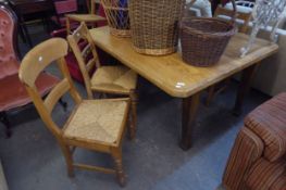 AN OAK FRAMED VICTORIAN DINING TABLE, WITH REPLACEMENT PINE TOP, THREE LADDER-BACK DINING CHAIRS,