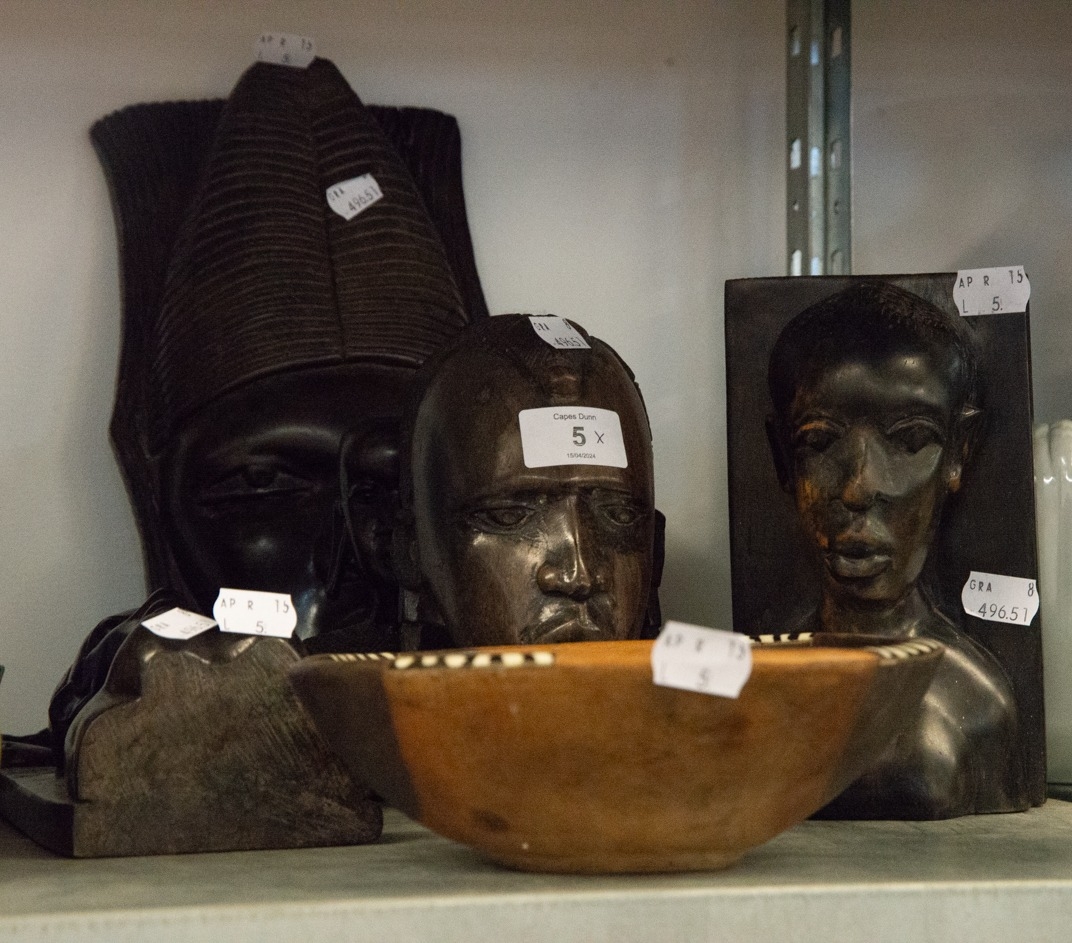 GROUP OF NIGERIAN EBONY WALL MASKS, BOOKENDS, PAPER KNIVES, SCULTURE AND BOWL (9)