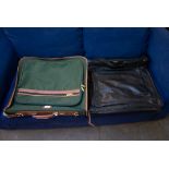 A GREEN CANVAS AND LEATHER MOUNTED SUITCASE, 22” WIDE AND A GENT’S BLACK LEATHER FOLD-OVER SUIT