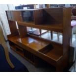 A LARGE MID-CENTURY TEAK EXTENDING ROOM DIVIDER, THE LOWER SECTION HAVING SHELVES, RECORD SLOTS