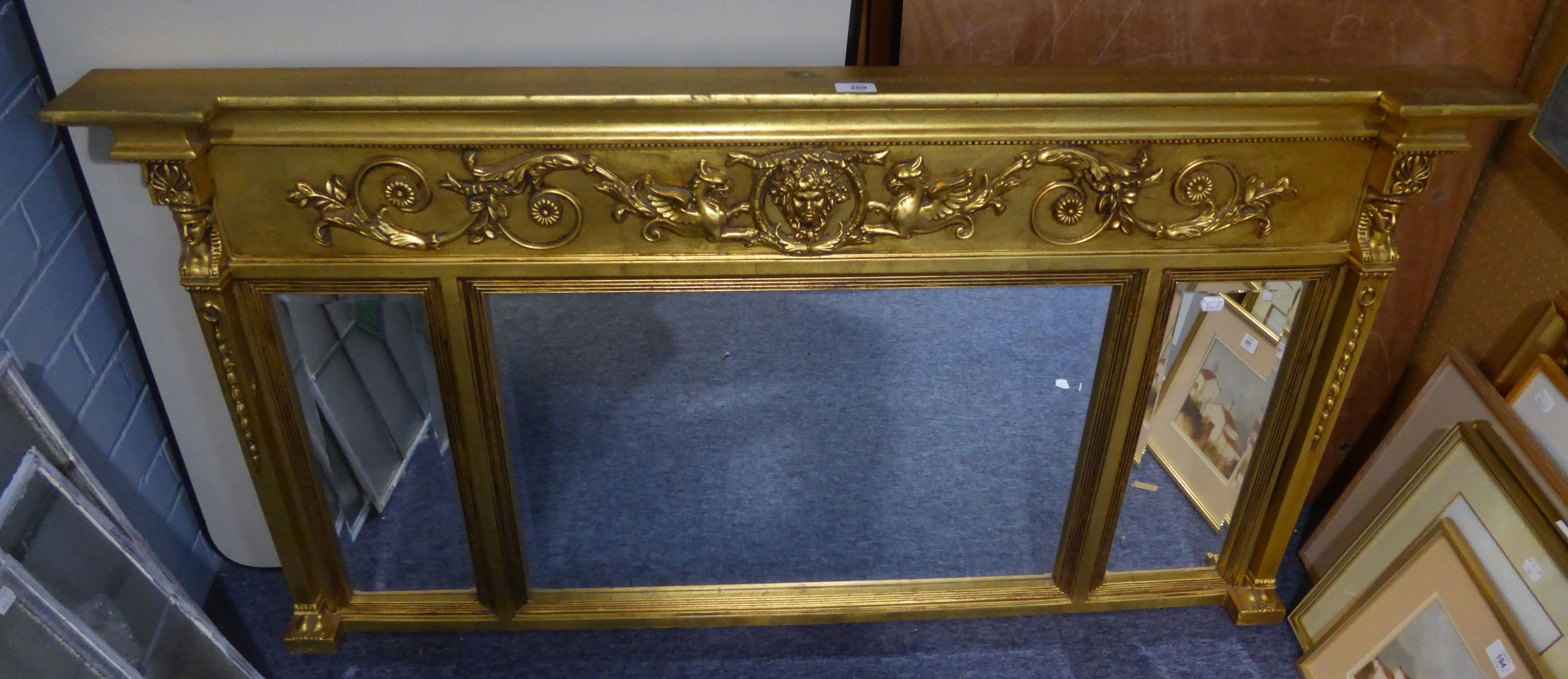A LARGE RECTANGULAR THREE SECTION GILT FRAMED OVER MANTEL MIRROR, WITH EMBOSSED DRAGON DECORATION
