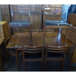 A MID-CENTURY TEAK EXTENDING DINING TABLE, HAVING FOLD-AWAY LEAF AND A SET OF SIX TEAK LADDER-BACK