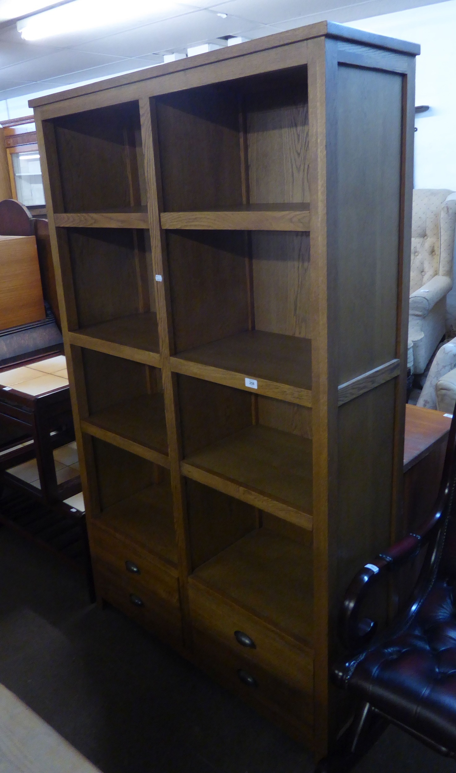 A GOOD QUALITY OAK BOOKCASE HAVING FOUR ADJUSTABLE SHELVES AND FOUR DRAWERS
